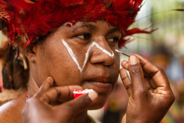 Port Moresby, 2013. A woman has her face painted in traditional patterns while preparing for the Independence Day celebrations, showcasing the great diversity of cultures in Papua New Guinea.