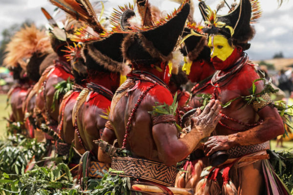 Goroka, 2014. The Huli wigmen perform a traditional singsing – they stand in two rows facing each other, jumping and chanting to the rhythm of a drum beat.