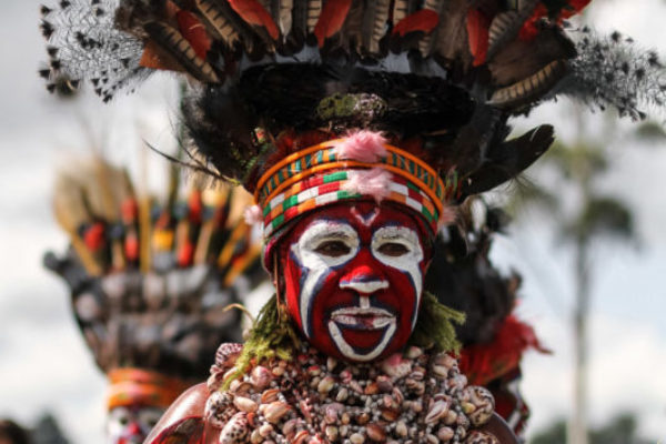 Goroka, 2014. The women from the Western Highlands have an elaborate cultural outfit – necklaces made from hundreds of shells, distinctive red and white face paint, and a crown of feather made from the bird of paradise and parrots.