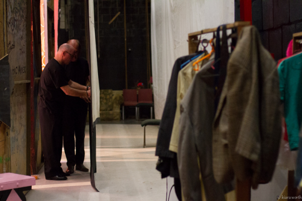 Backstage hands make final preparations to the set