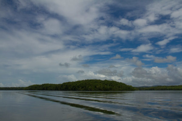 As the ocean meets the river, the beauty of the day is reflected in the water.