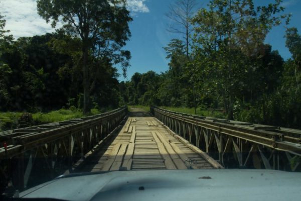 One of the bridges that crosses over a deep river, seemingly made of rickety wooden planks.