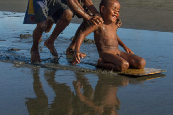 A slippery happiness: three bays play on the beach of Iokea village, a moment of delight shared by all. Photo won first place in the Papua New Guinea Amateur Photography Awards and published in Paradise Magazine..