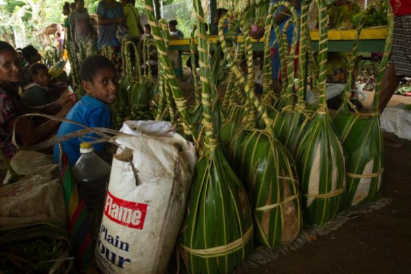 Sago wrapped in banana leaf bags for sale at the local market in Kerema.