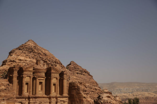 The intricate carvings of the Monastery are a stark contrast to the rough rock that surrounds it.