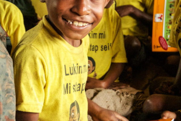 Porohali, Hela Province, 2014. Since the construction of a road throughout the Hides region, road safety has become a primary concern for local villages. High visibility safety vests have since become a standard uniform throughout the area.