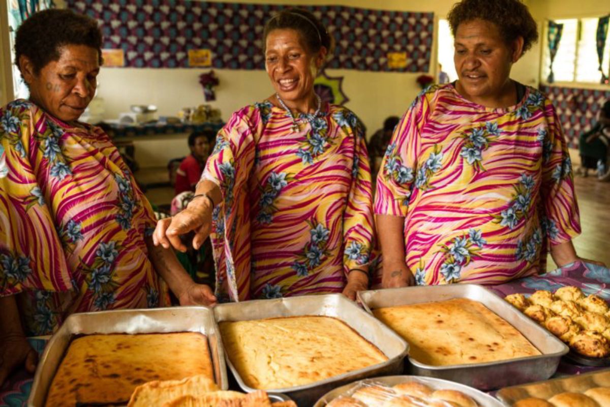 Paua, Southern Highlands Province, 2015. Women from the Paua Women’s Group proudly look over their display of freshly baked goods