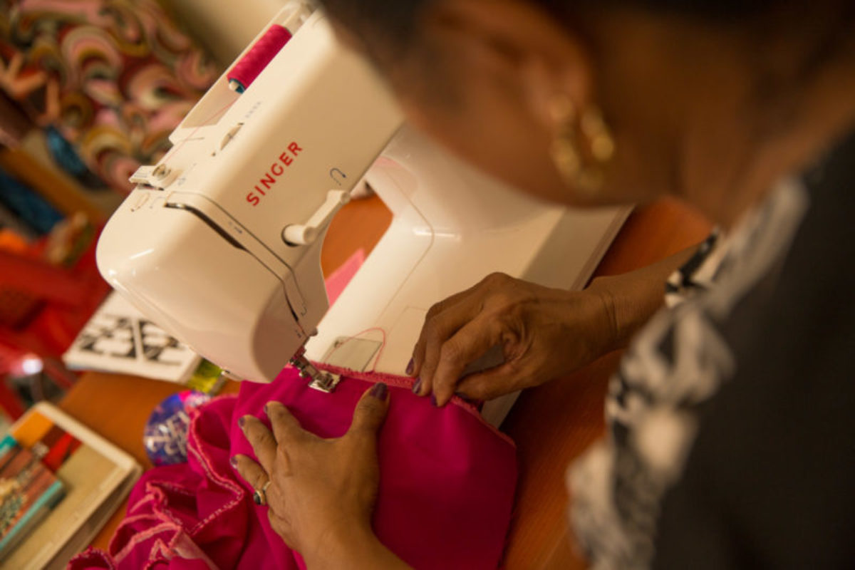 Porebada, 2018. A woman sews a traditional ‘meri blouse’ as part of her new home business, aimed at increasing economic resilience.