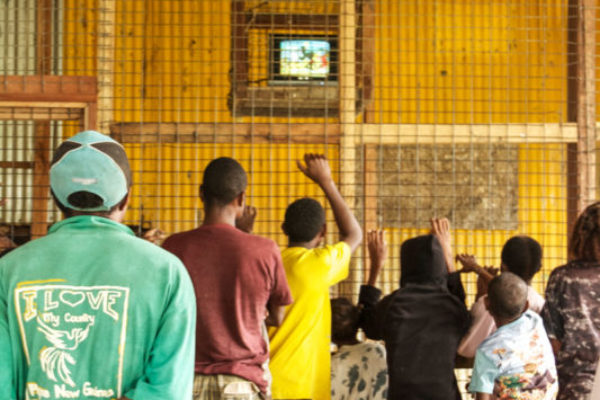 Kinumere, Gulf Province, 2012. In the remote villages along the Kikori river, there is little access to modern technologies or even electricity. In Kinumere village, a local shop owner installed a television, run on a generator and kept in a large cage to protect it from on-lookers.