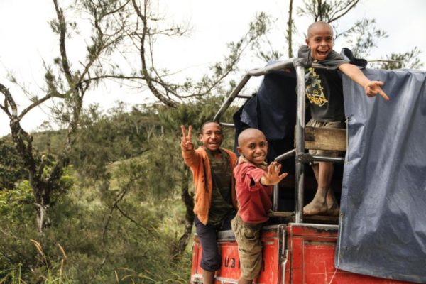 Mendi, Southern Highlands Province, 2012. Young boys catching a ride along the Highlands Highway, the main land highway in the country.