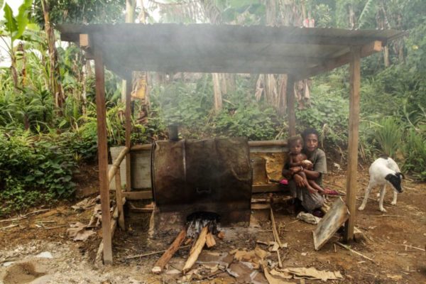 Hides, Hela Province, 2012. Drum ovens, fueled by wood collected from the forest, are a common way of preparing food in the village.